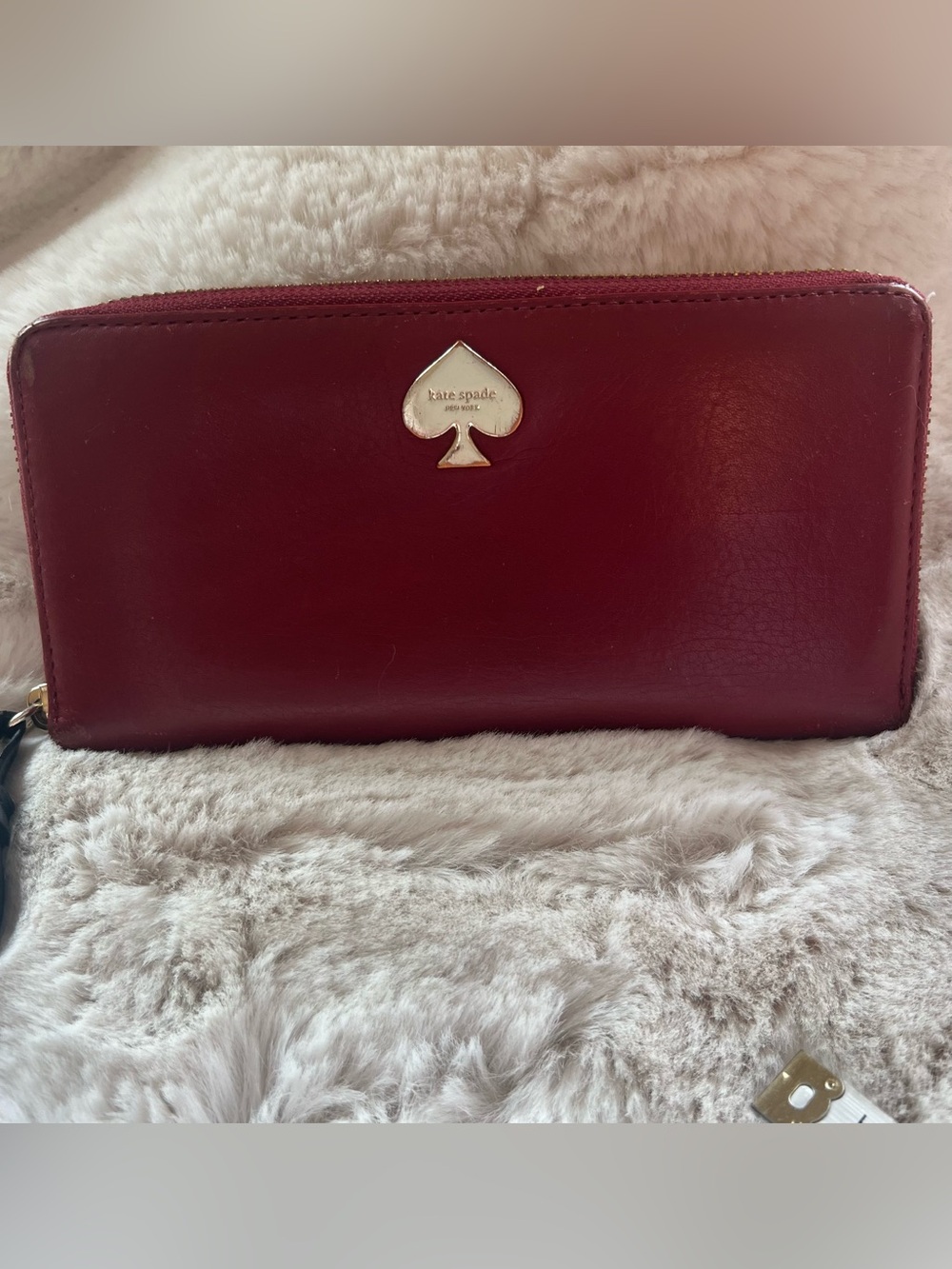 kate spade burgundy leather zip-around wallet with gold spade logo